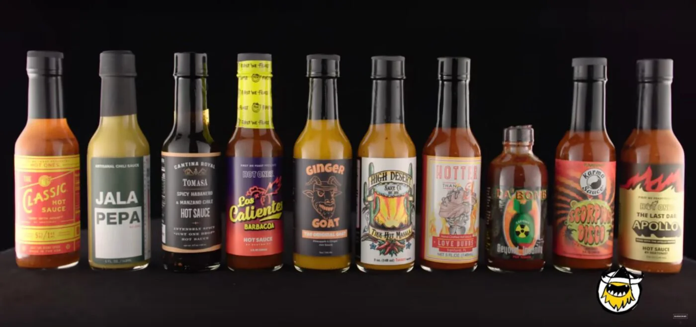 a row of bottles of hot sauce